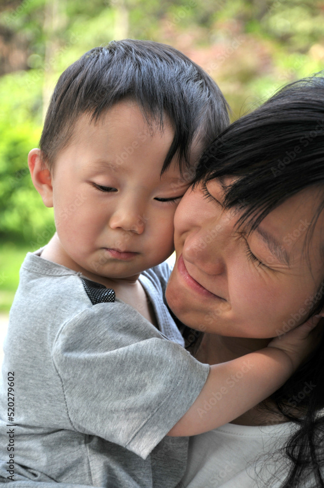 mother and child are playing in garden mother and child are playing in garden