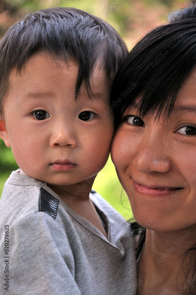 mother and child are playing in garden mother and child are playing in garden