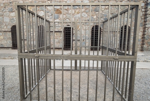 Old Iron Prison Cell Bars and Stone Wall in Courtyard of Famous Yuma Territorial Prison State Historic Park