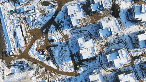 Aerial view of the winter cottages construction on the modern ski resort surrounded by forest. Motion. Sports and recreation concept © Media Whale Stock