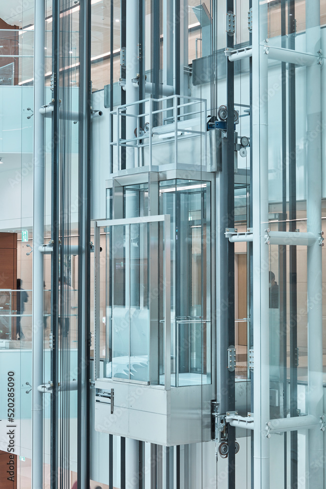 Obraz premium Glass Elevator Shaft Detail, Modern Building Interior Architecture