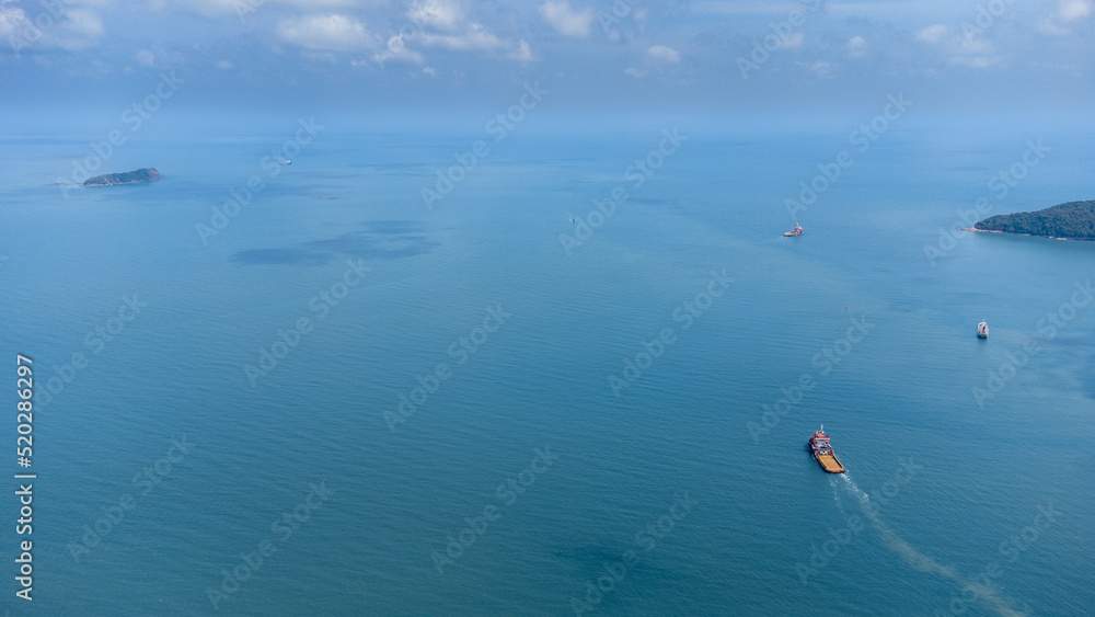 Aerial side on top view of cargo ship carrying container and running for export cargo yard port to custom in international ocean.