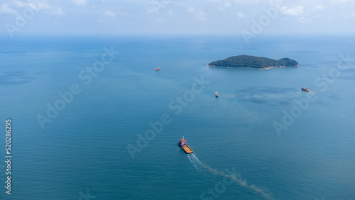 Aerial side on top view of cargo ship carrying container and running for export cargo yard port to custom in international ocean.