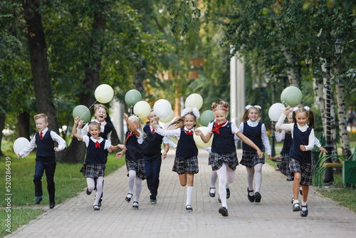 Schoolchildren run with balloons