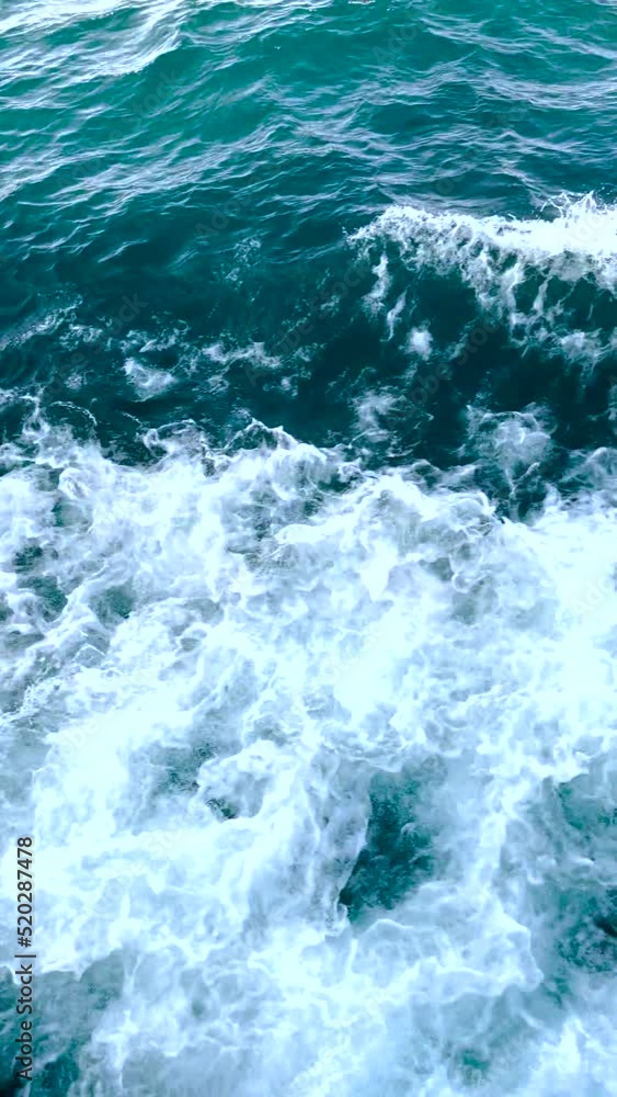 Large nautical vessel glides through the sea creating beautiful, big waves crashing about. Rough lake water splashes and sprays waves against deep blue sea water. Large nautical vessel glides through the sea creating beautiful, big waves crashing about. Rough lake water splashes and sprays waves against deep blue sea water.