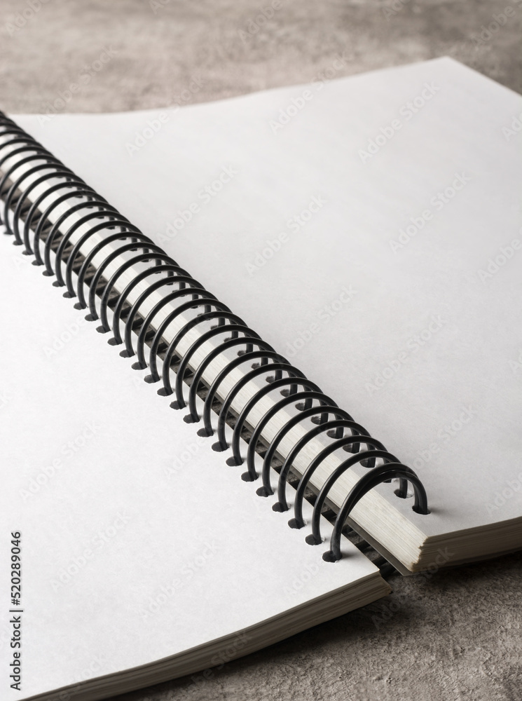 opened book with wire spiral binding on table top, blank and line white pages, selective focus Stock-foto | Adobe Stock