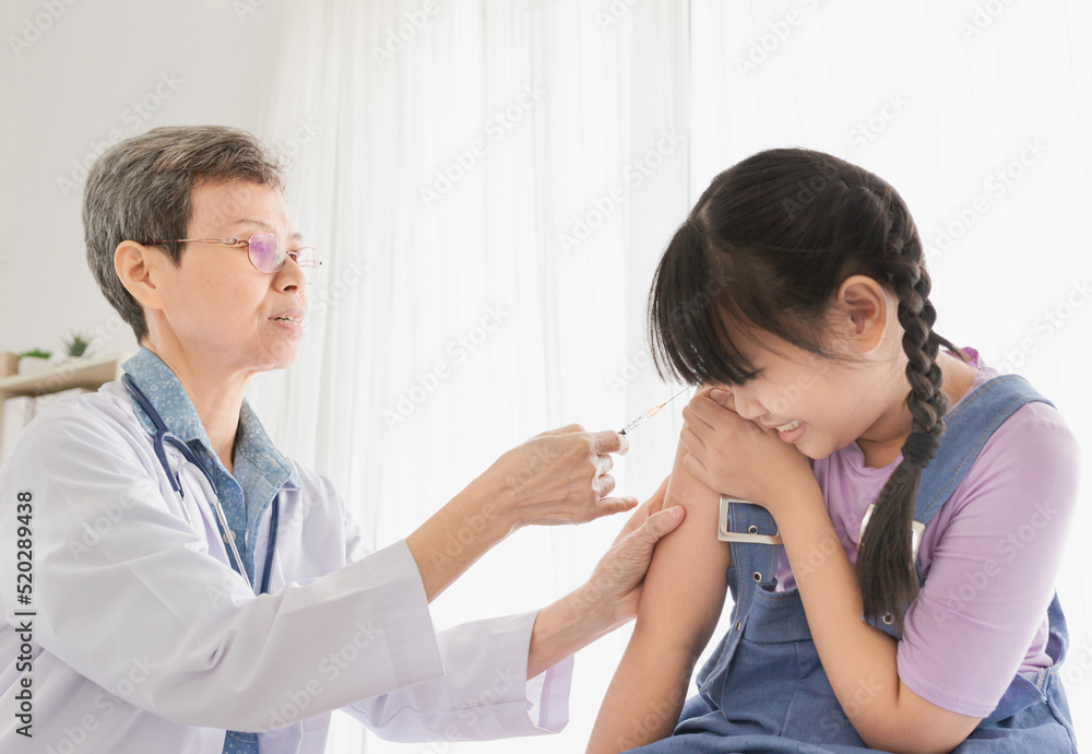 light and blur people, doctor inject vaccine to asian girl, Deltoid muscle injection technique, children immunization and health care promotion light and blur people, doctor inject vaccine to asian girl, Deltoid muscle injection technique, children immunization and health care promotion