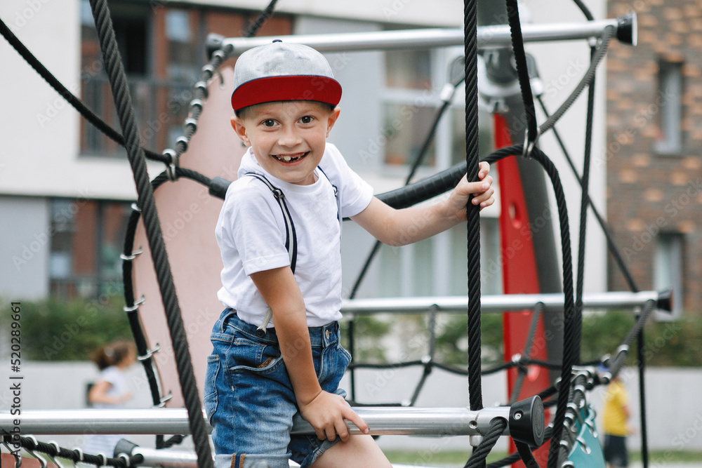 Boy on rope simulators at the city playground. Boy on rope simulators at the city playground.