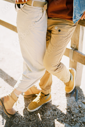 Legs of a man and a woman in trousers and boots