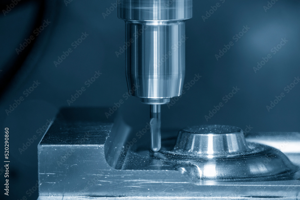 Close-up scene the CNC milling machine cutting press die by solid ball end mill tool. Close-up scene the CNC milling machine cutting press die by solid ball end mill tool.