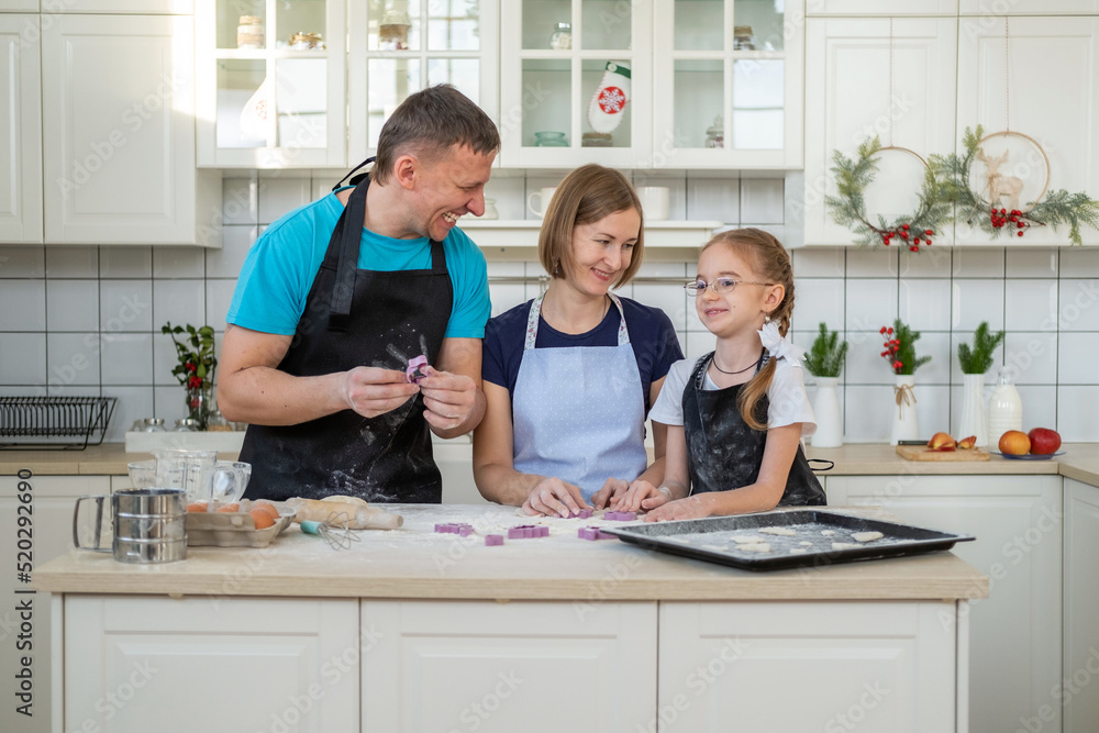 Happy Family of Three Preparing Bakery Together at Home, Making Delicious Cookies Happy Family of Three Preparing Bakery Together at Home, Making Delicious Cookies