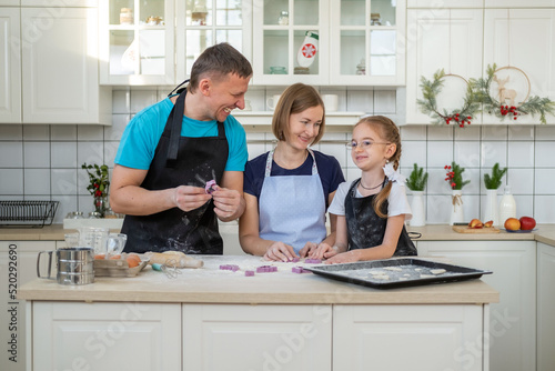 Happy Family of Three Preparing Bakery Together at Home, Making Delicious Cookies
