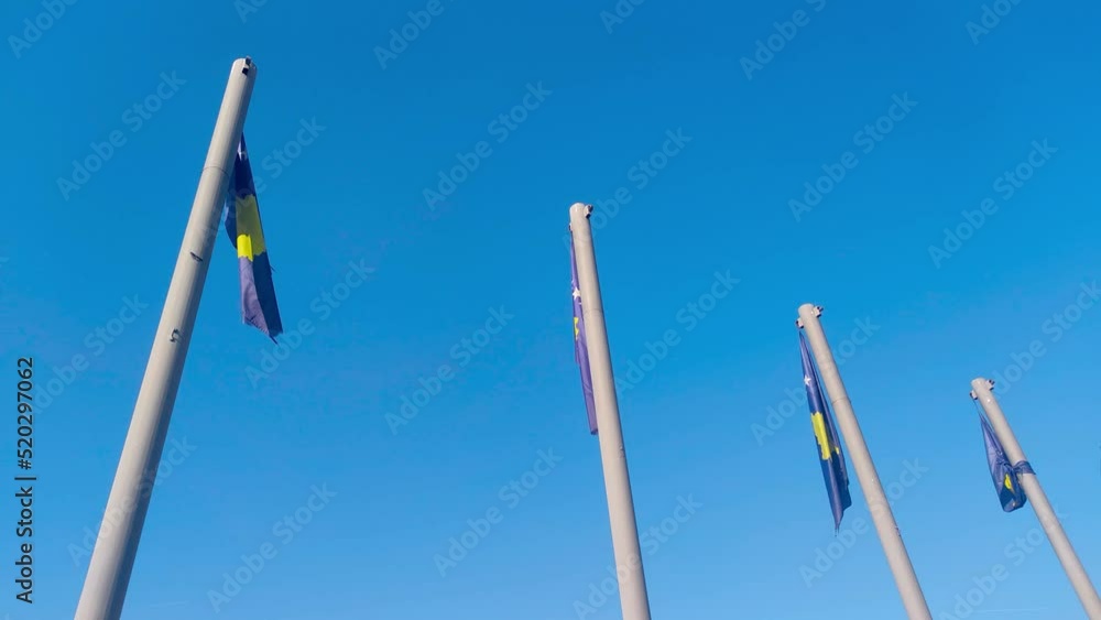 National flags of Kosovo waving on blue sky. National flags of Kosovo waving on blue sky.