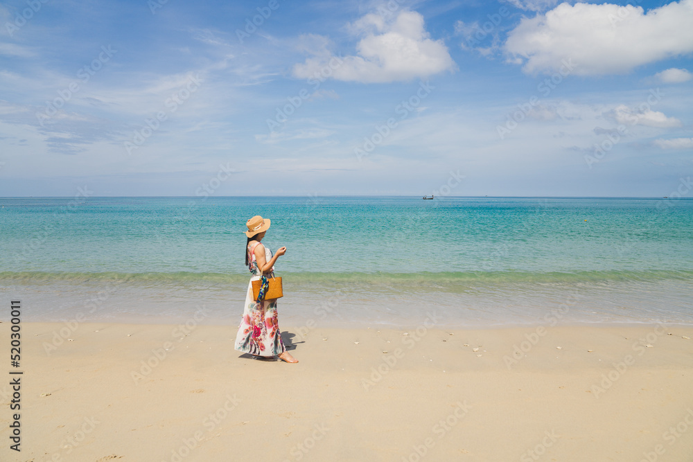 Asian women stand on the beach. Phuket Sea Beach, Mai Khao Beach, Thailand