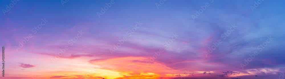 The panoramic image shows the natural phenomenon of the sky with multicolored clouds at twilight.