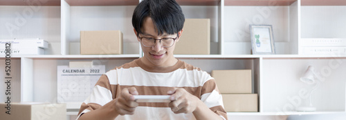 Man taking a photo of product in box postbox with a mobile phone or Selfie, Identity verification or order confirmation, Business style for working at home, Working at home and owning businesses.