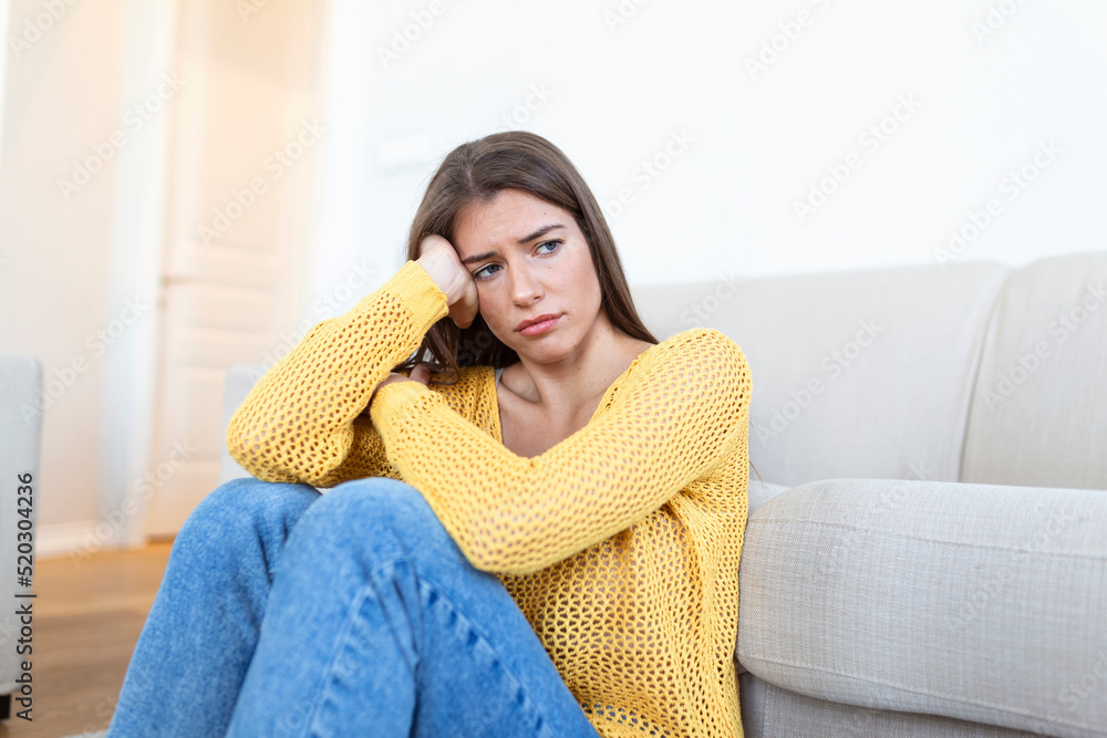 anxious worried woman sitting on couch at home. Frustrated confused female feels unhappy, problems in personal life, quarrel break up with boyfriend and unexpected pregnancy concept anxious worried woman sitting on couch at home. Frustrated confused female feels unhappy, problems in personal life, quarrel break up with boyfriend and unexpected pregnancy concept