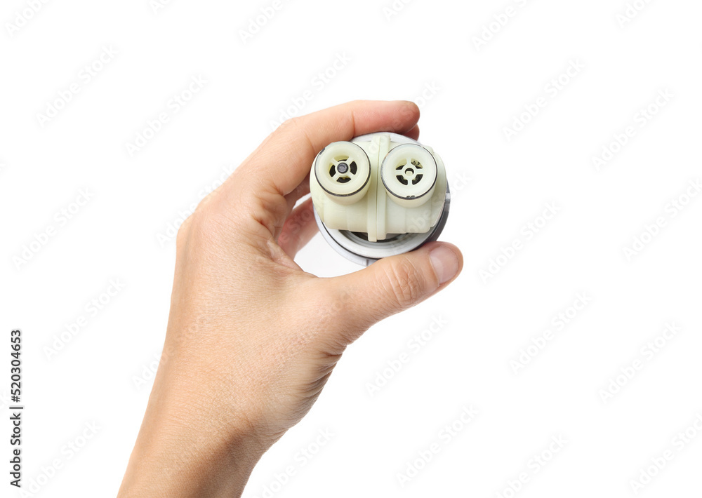 Hand holding bathroom faucet cartridge. Old broken cartridge from single handle faucet, water could not be shutoff. Plumbing service or handyman service concept. Selective focus. White background.
