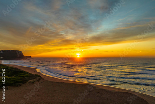 Sunrise and high cloud cover by the sea and lagoon © Merrillie