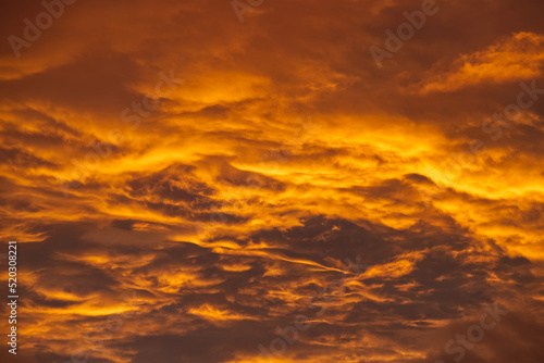 Swirling evening clouds illuminated by the setting sun