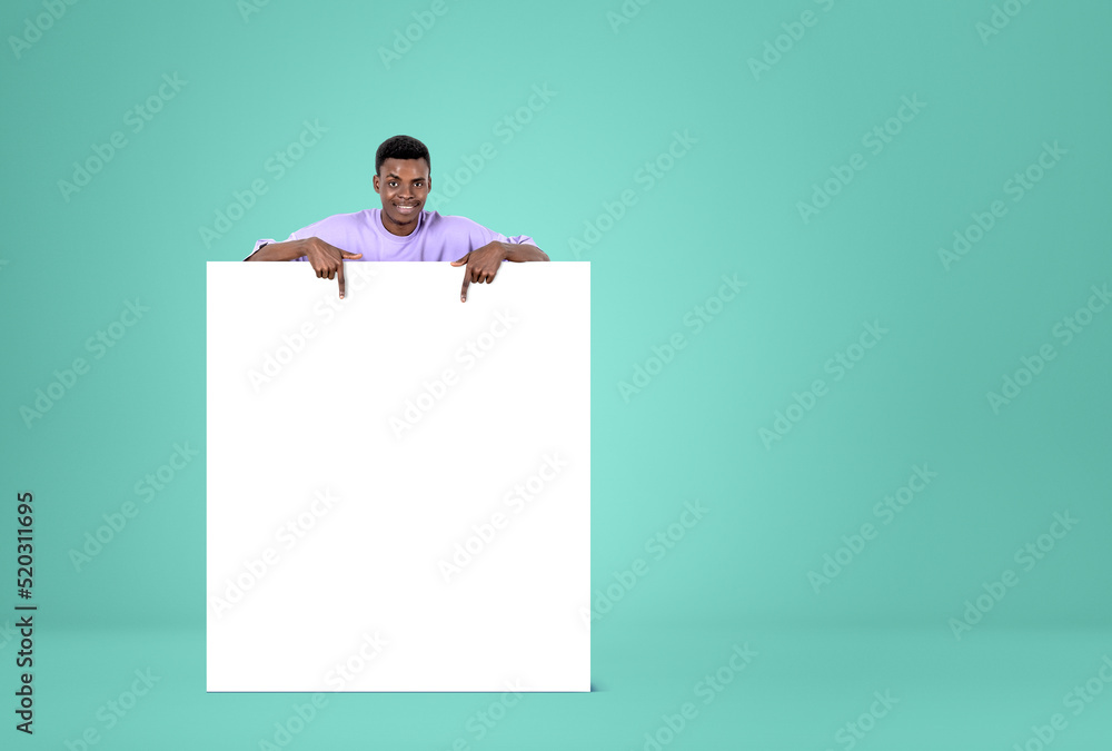 African man fingers pointing at mockup canvas on green background African man fingers pointing at mockup canvas on green background