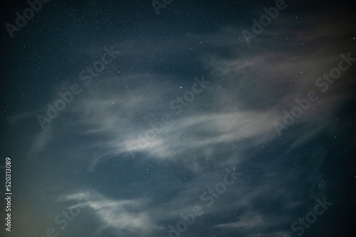 Stunning noctilucent cloud formations against Milky Way background night sky