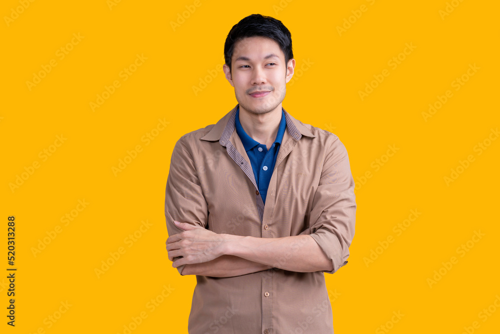smart casual asian male adult casual shirt hand touch his chin inspired ideas thinking action pose look at camera studio shot on yellow colour background smart casual asian male adult casual shirt hand touch his chin inspired ideas thinking action pose look at camera studio shot on yellow colour background