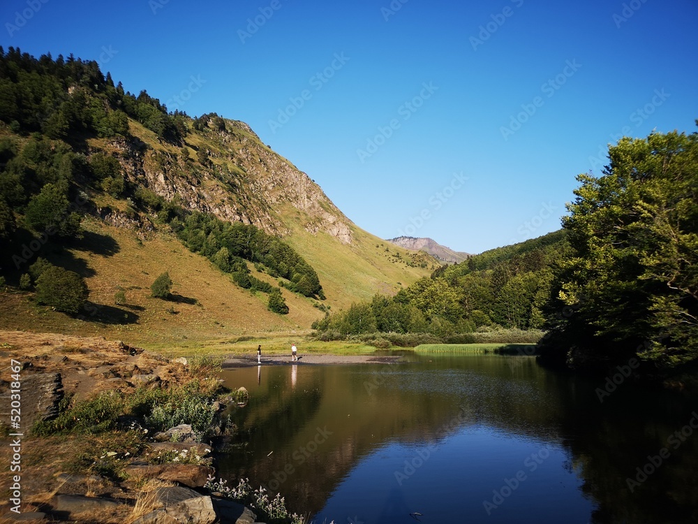landscape in the mountains with meadow and lake in Pyrenees