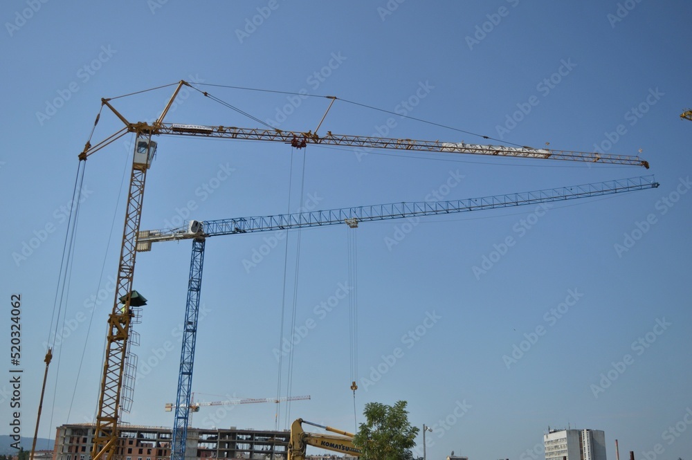 Many cranes on the construction site of a multi-storey residential and commercial complex Many cranes on the construction site of a multi-storey residential and commercial complex
