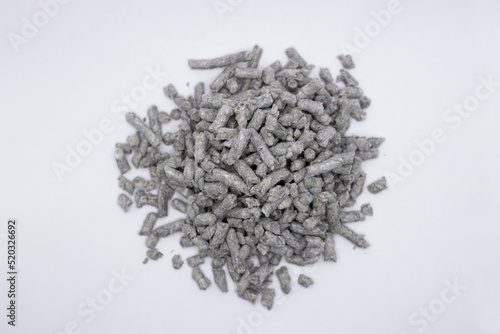 shallow depth of field photo of recycled Paper cat litter pellets on a white background