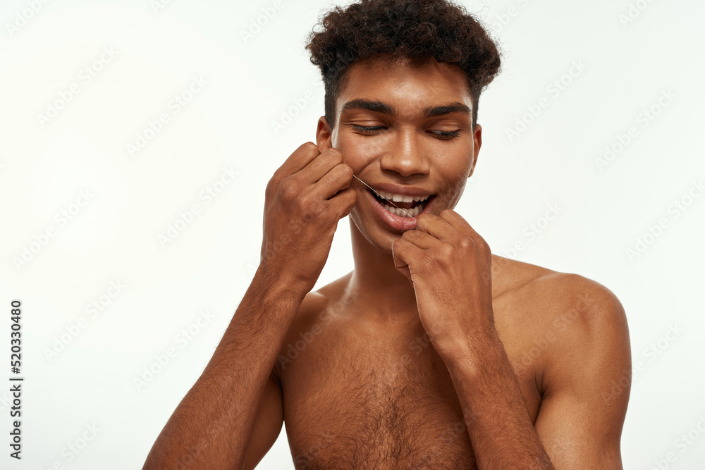 Partial of black guy brush teeth with dental floss Partial of black guy brush teeth with dental floss
