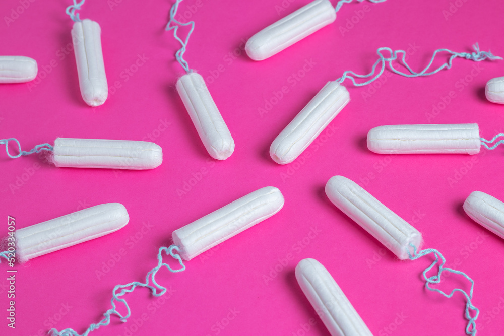 Medical female tampon on a pink background. Hygienic white tampon for women. Menstruation, means of protection. Medical female tampon on a pink background. Hygienic white tampon for women. Menstruation, means of protection.