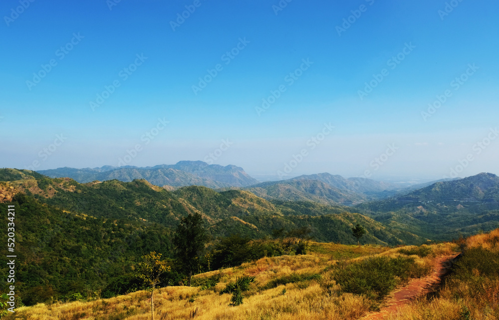 Fototapeta premium Mountain scape at Khao Kho National Park & Hot Springs in the morning at Phetchabun of Thailand in Winter, Sunny day and blue sky, Beautiful Natural View in Thailand, Natural wallpaper and background