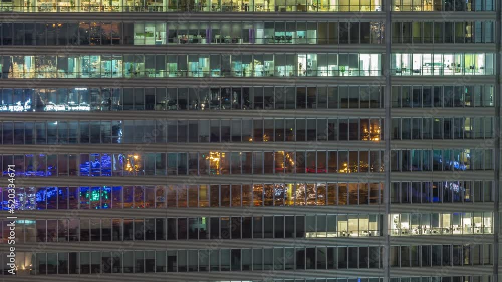 Windows of office buildings during all night timelapse, the lights turning off in the windows of skyscrapers. Evening landscape of the city with glowing working space Windows of office buildings during all night timelapse, the lights turning off in the windows of skyscrapers. Evening landscape of the city with glowing working space