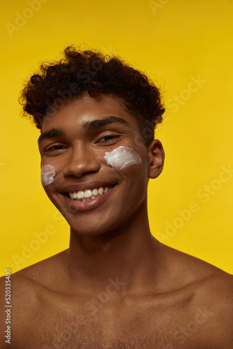 Black guy with cream on face looking at camera