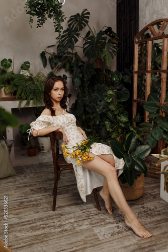Beautiful girl in a dress sits on a chair © Kaplitskaya Love