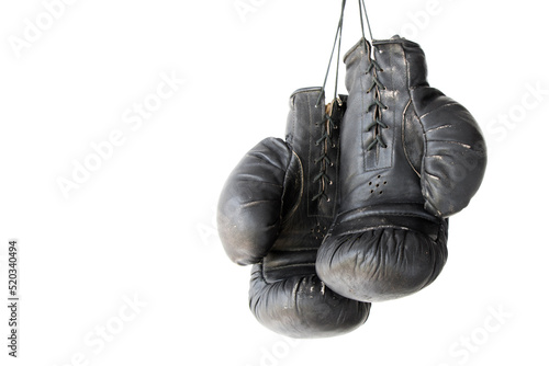hanging old worn leather boxing gloves isolated on white background © OLEKSANDR