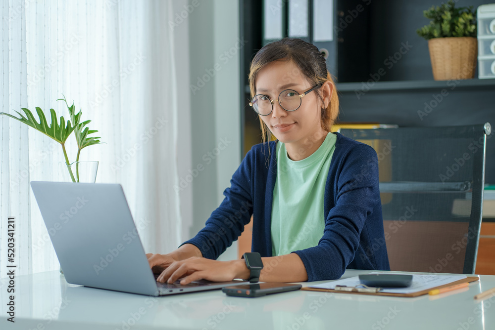 Portrait of a young asian woman freelancer working at home. Portrait of a young asian woman freelancer working at home.