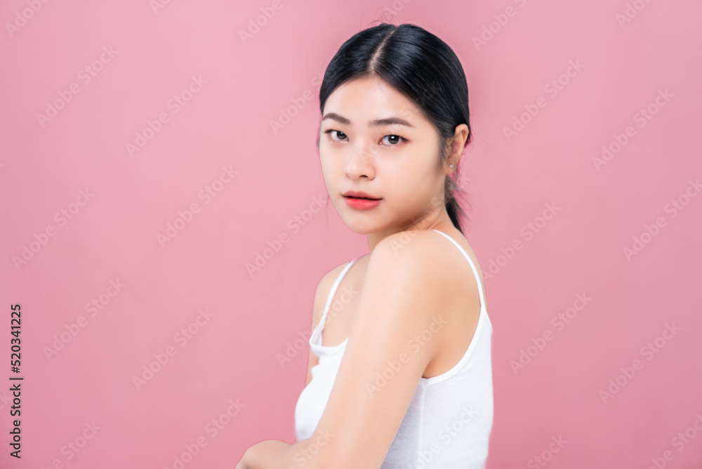 Beautiful Asian girl looking at camera isolated on pink background Beautiful Asian girl looking at camera isolated on pink background