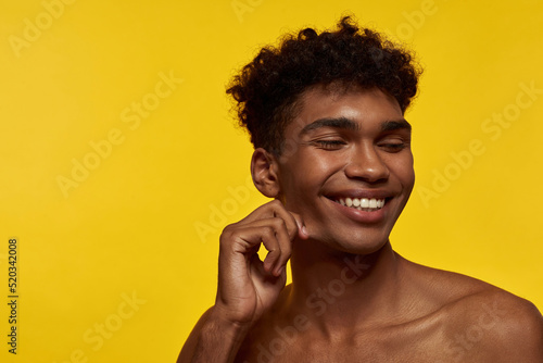 Smiling black good-looking guy with closed eyes © Svitlana