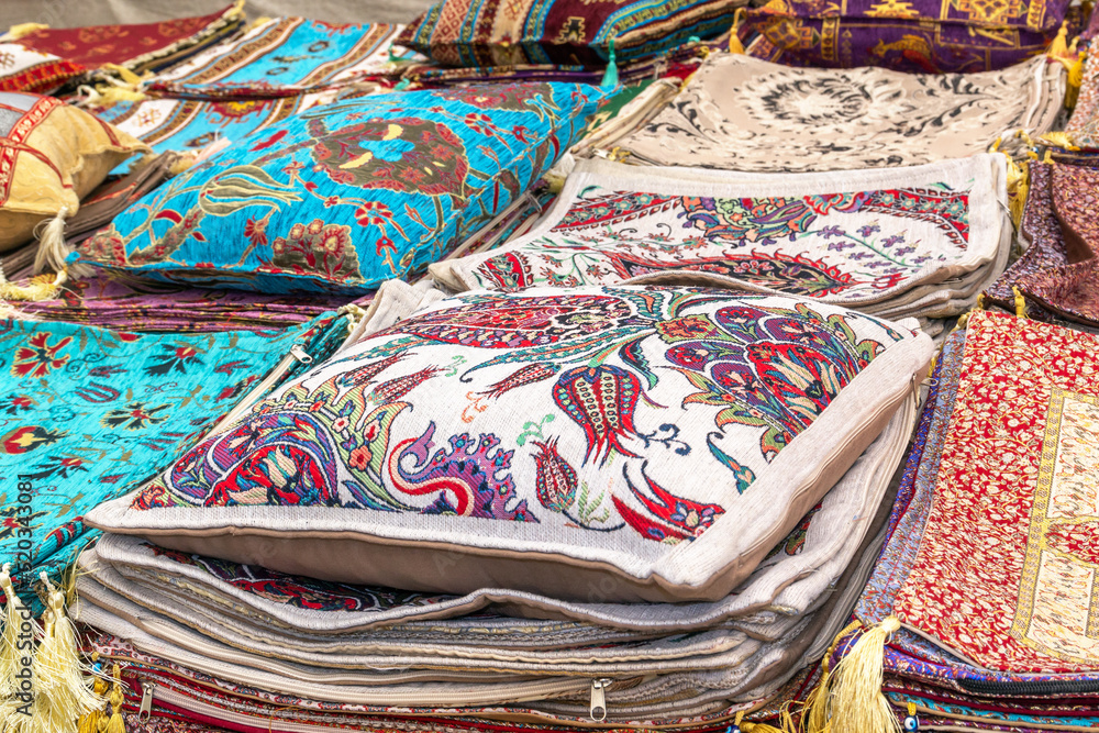 Pillows, pillowcases and handmade woven bedspreads in traditional Turkish style are sold at a street market