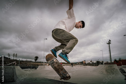 young skater jumps a ramp with his skateboard