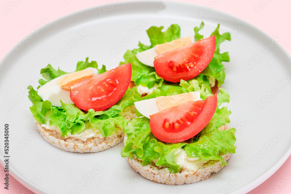 Rice Cake Sandwiches with Tomato, Lettuce and Egg on White Plate. Easy Breakfast. Diet Food. Quick and Healthy Sandwiches. Crispbread with Tasty Filling. Healthy Dietary Snack Rice Cake Sandwiches with Tomato, Lettuce and Egg on White Plate. Easy Breakfast. Diet Food. Quick and Healthy Sandwiches. Crispbread with Tasty Filling. Healthy Dietary Snack