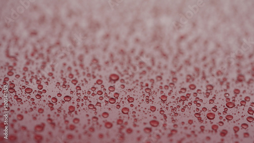 Fotografie water beading on red car with hydrophobic coating
