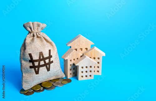 Houses and south korean won money bag. Real estate investment and rental business. Increasing property value. Home taxation. Residential or commercial property income. Municipal budget.
