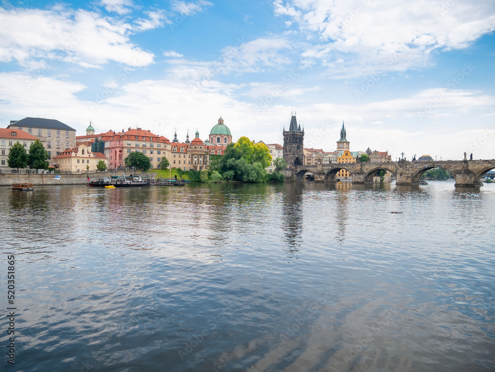 View with the Charles Bridge main touristic attraction . Medieval stone arch bridge over Vltava river in Prague