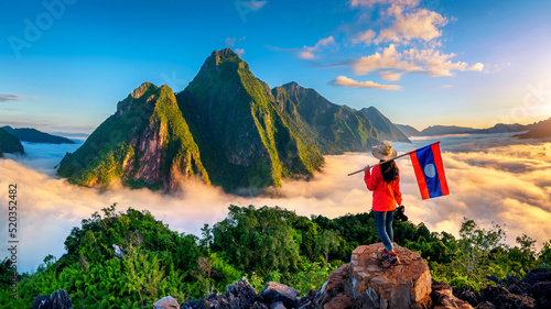 Obraz na płótnie Tourist standing on Pha Dang viewpoint at sunrise in Muang Ngoy, Laos