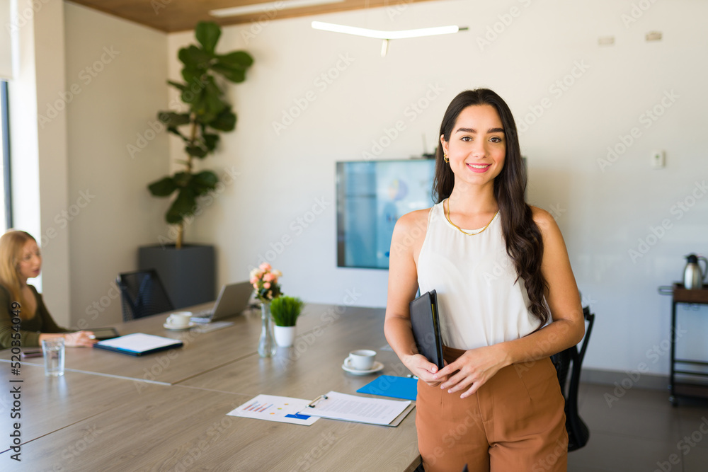 Young woman boss smiling during a work meeting Young woman boss smiling during a work meeting