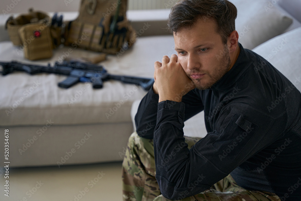 Stressed male soldier on leave at home from war Stressed male soldier on leave at home from war