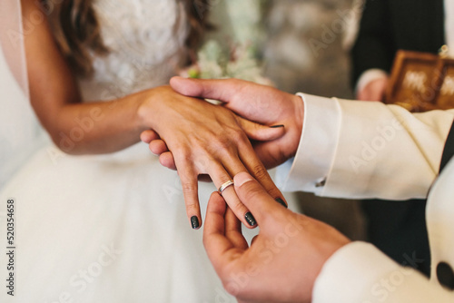 Bride and groom exchange rings at the wedding ceremony © tsezarina